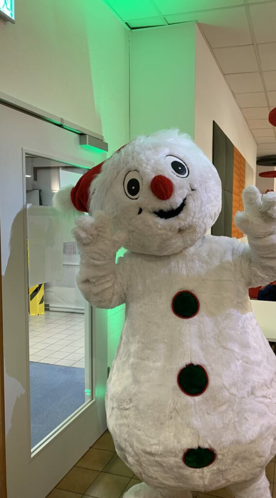 Mascotte Bonhomme de neige qui accueille les enfants à leur arrivée